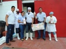 Alcalde Muñiz y trabajadores muestran el vaso escolar y el queso pasteurizado