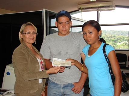 Blanca González, directora de Despacho hace entrega del cheque a los estudiantes de la UNEG Upata para viajar a Mérida.